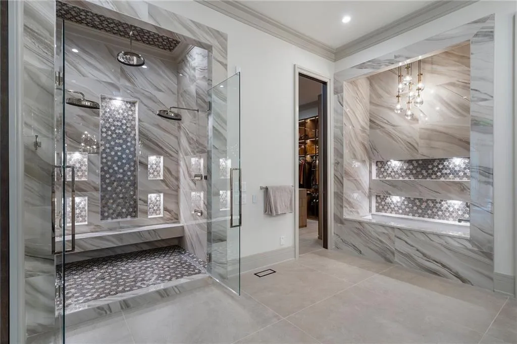 Primary Suite Bath, double shower systems with 3 shower heads + rotating body sprays, soaking tub, separate his/hers closets and water closets