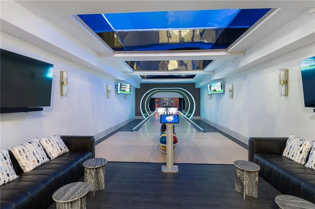 Two 50' bowling alley lanes with glass bottom swimming pool above, stunning effect!!