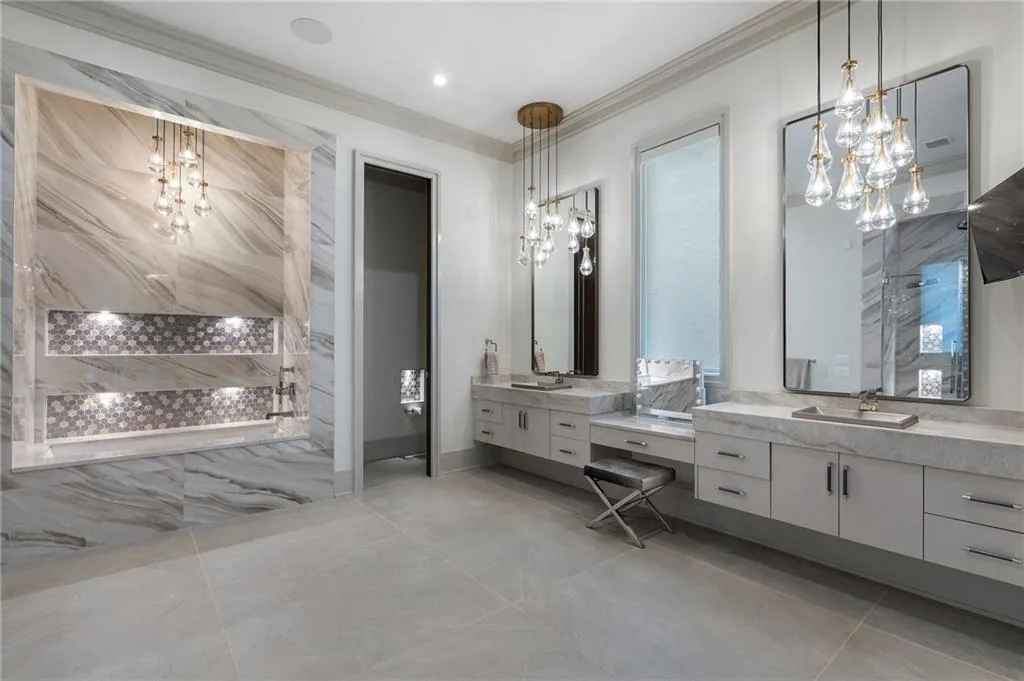Primary Suite Bath, double shower systems with 3 shower heads + rotating body sprays, soaking tub, separate his/hers closets and water closets