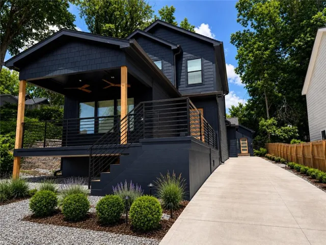Dark-hued exterior siding and trim with wood accents