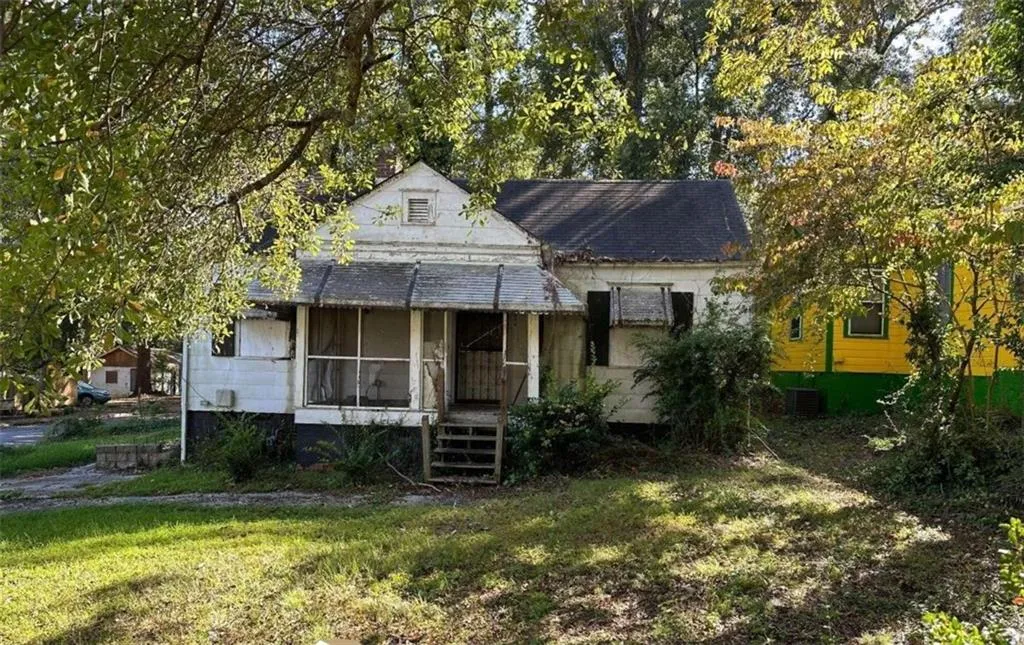 Bungalow-style house featuring central AC and a front lawn