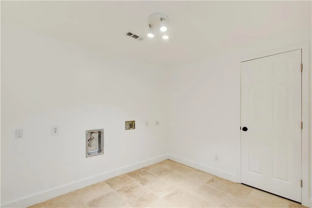 Laundry area with washer hookup and baseboards
