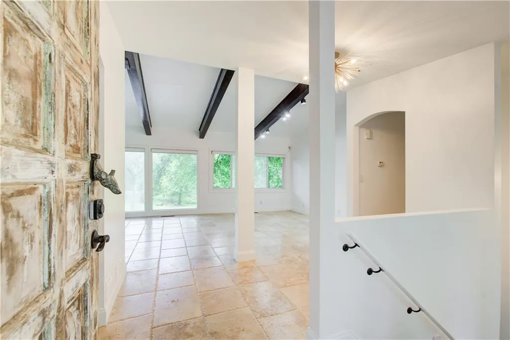 Entrance foyer with arched walkways and baseboards