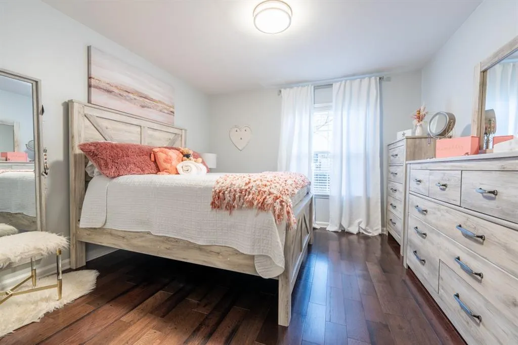 Guest Bedroom/Bedroom 3 with baseboards and dark wood-type flooring