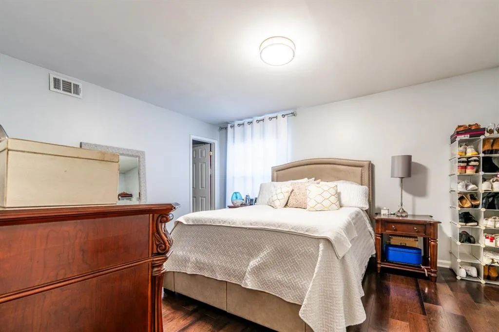 Master Bedroom with visible vents and dark wood-style flooring