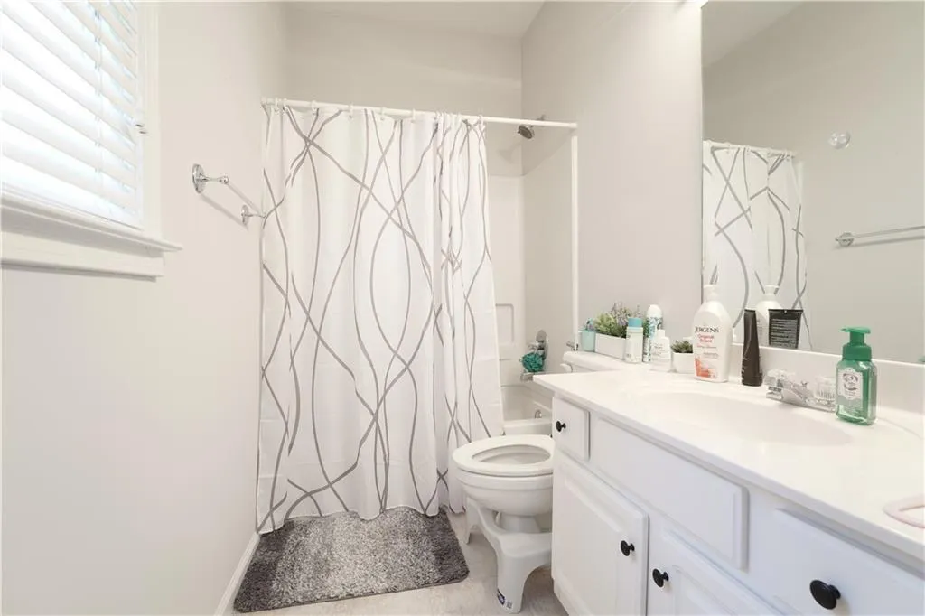 Full bathroom featuring vanity and shower / bath combo with shower curtain