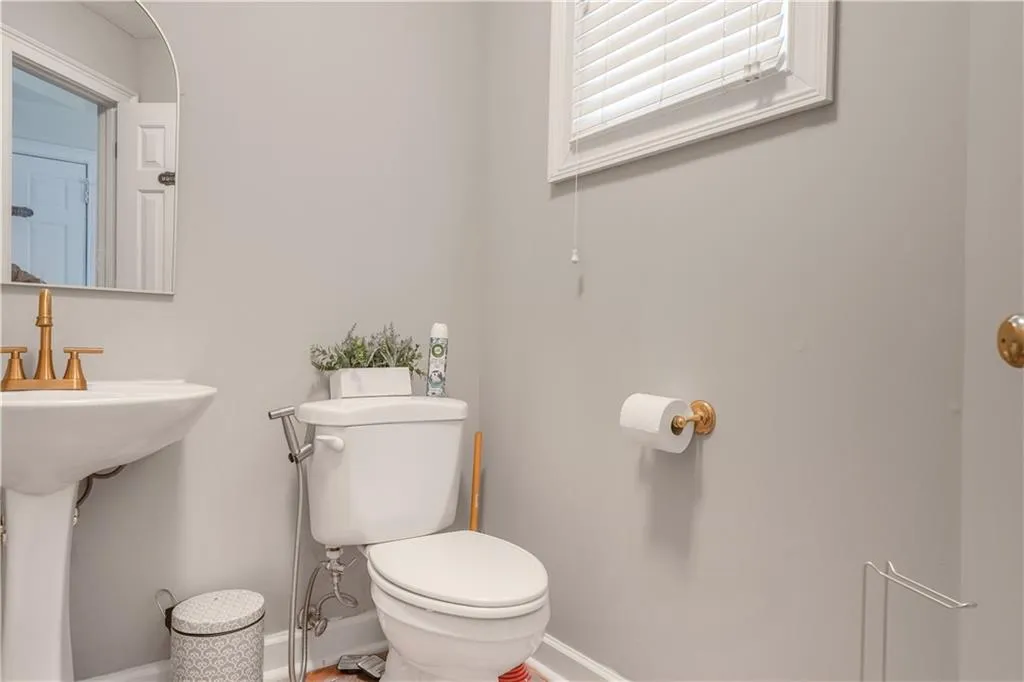 Bathroom with toilet and baseboards
