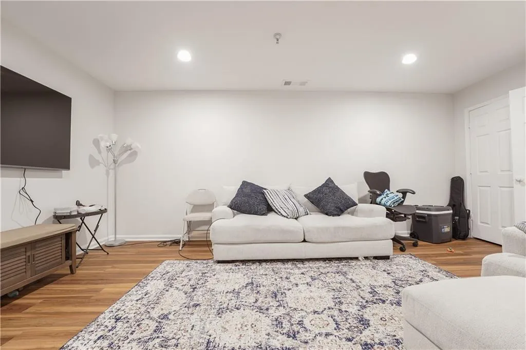 Living area featuring recessed lighting and light wood-style flooring