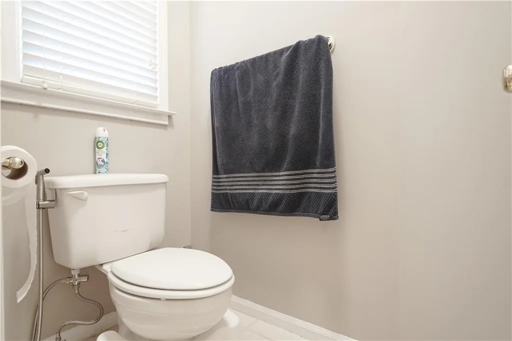 Half bathroom with baseboards and tile patterned flooring