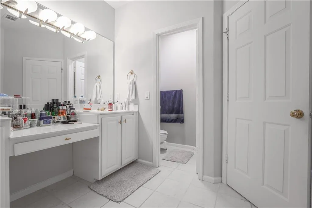Bathroom with vanity and light tile patterned flooring