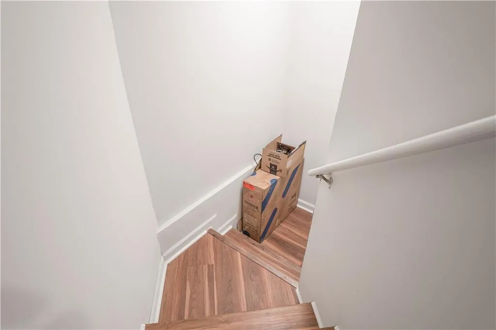 Stairway featuring wood finished floors
