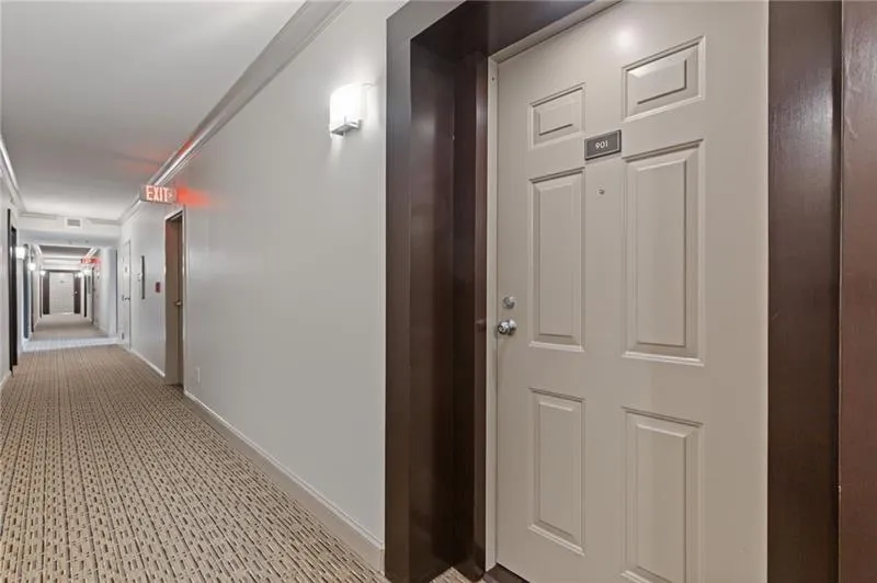 Corridor with ornamental molding and baseboards