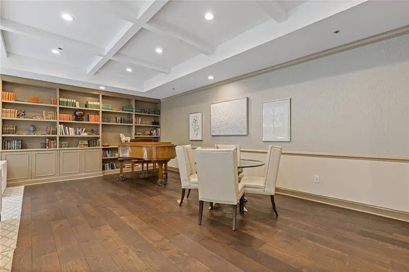 Dining room with beamed ceiling, dark wood-type flooring, recessed lighting, and coffered ceiling