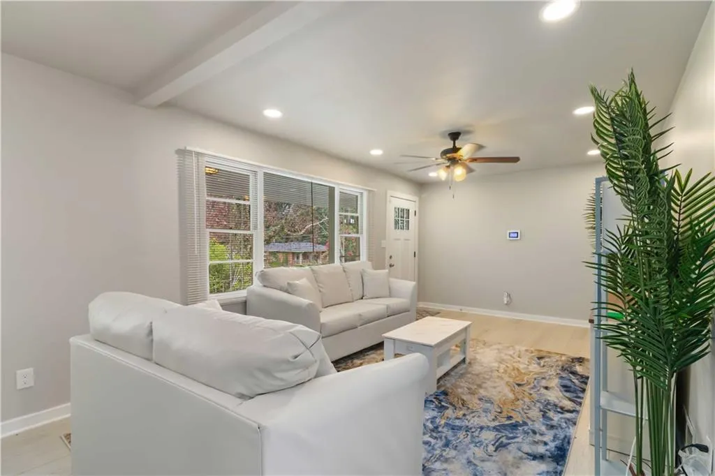 Living room featuring light wood-style flooring, recessed lighting, and ceiling fan