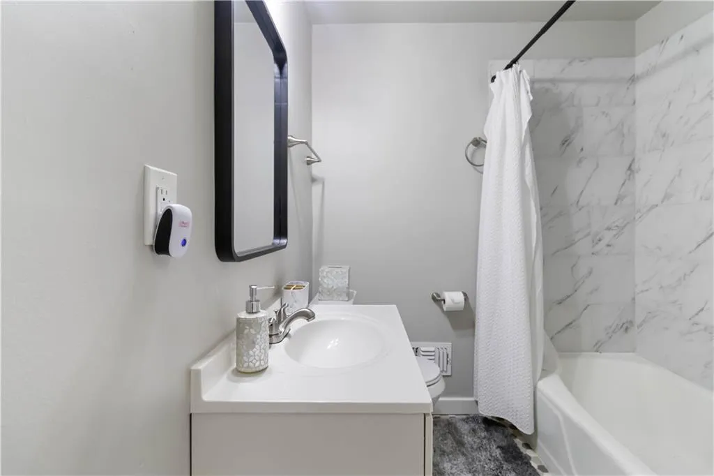 Bathroom featuring shower / tub combo and vanity