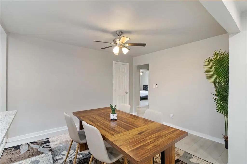 Dining space featuring baseboards and a ceiling fan
