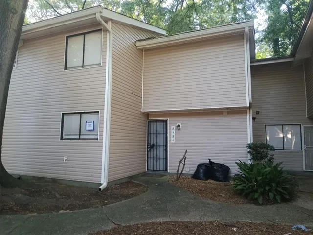 Two-story exterior with light-colored siding
