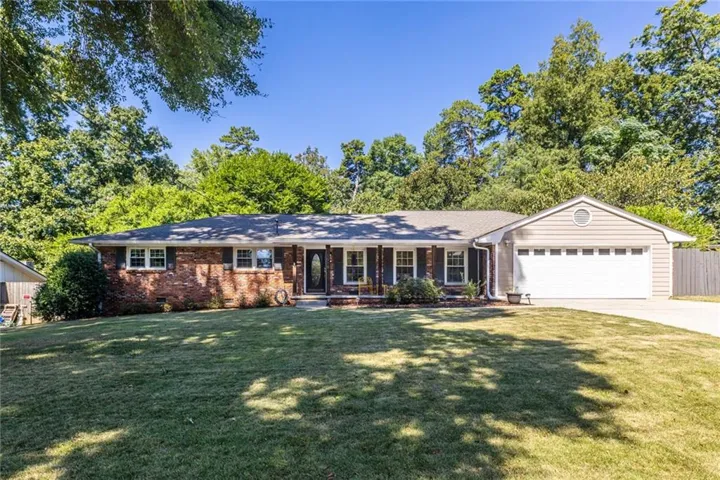 Classic all-brick ranch with beautifully manicured landscaping and timeless curb appeal.