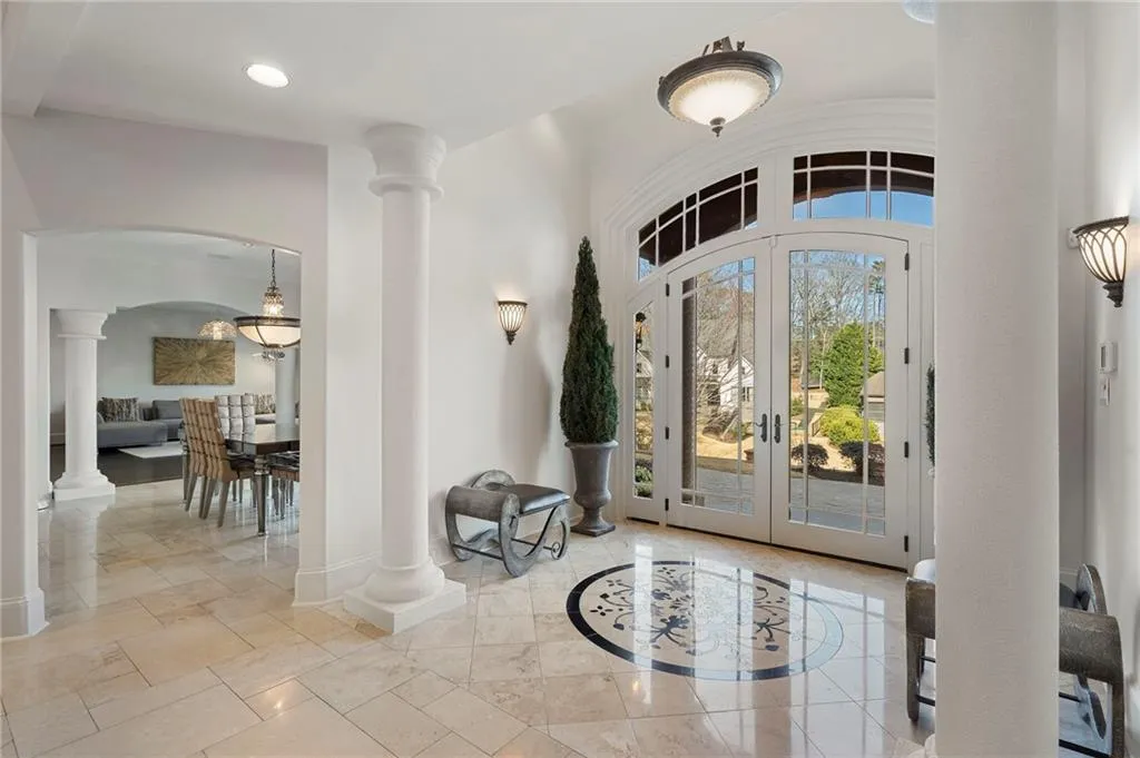 Walk into high ceilings, stone floors and two story living room with fireplace.