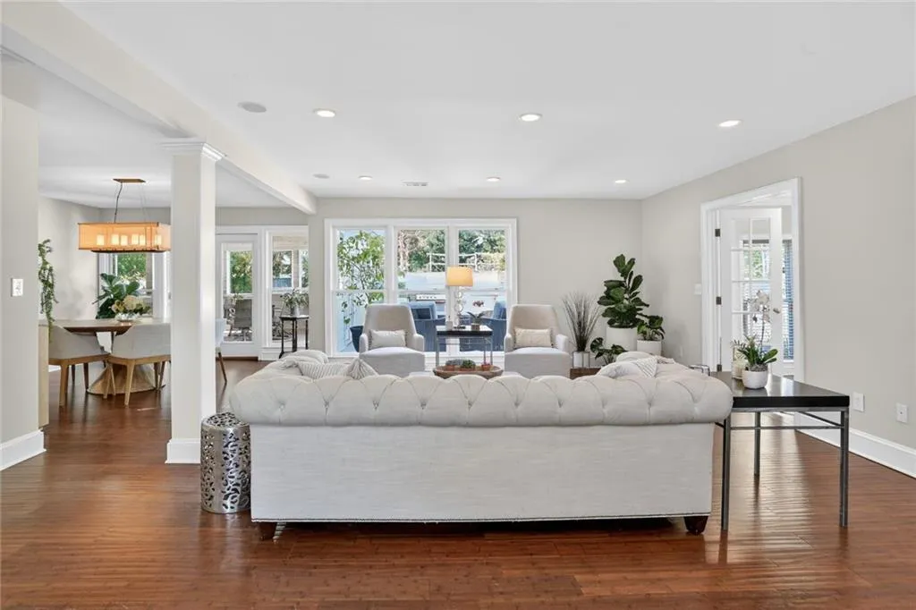 Living room with dark wood-style flooring and recessed lighting