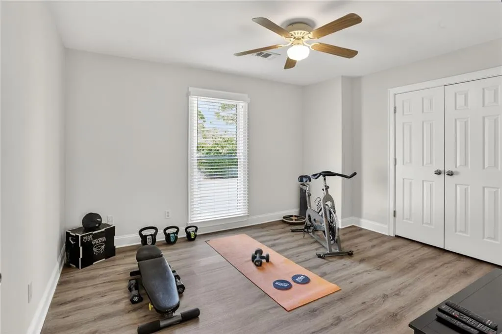 Workout room featuring wood finished floors and a ceiling fan