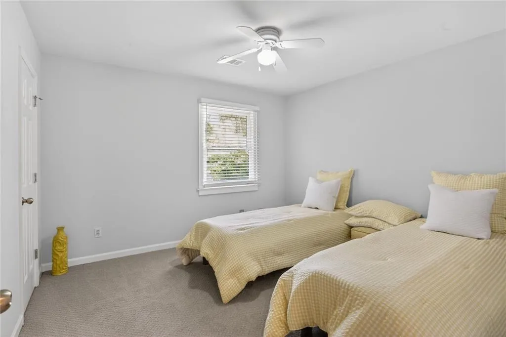 Bedroom with carpet and ceiling fan