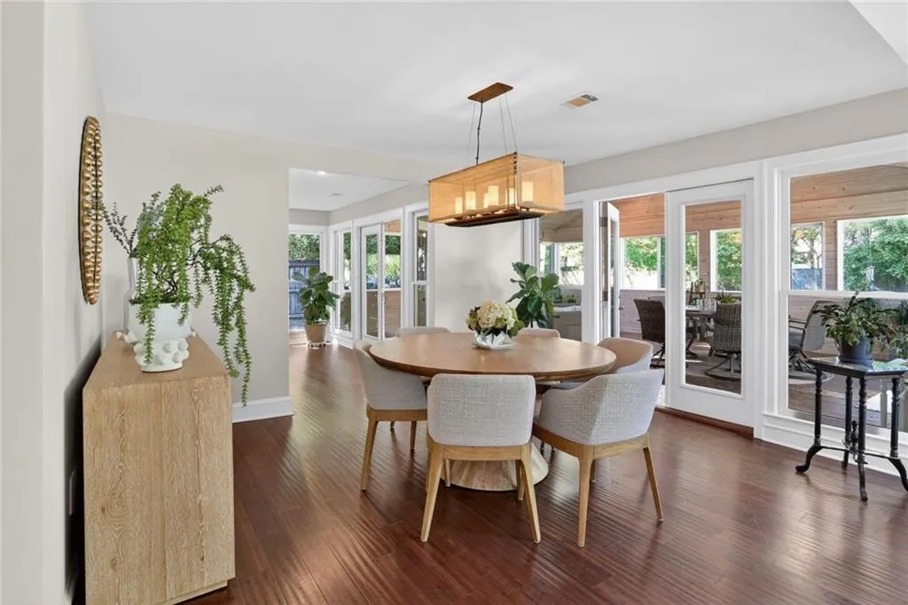 Dining area with dark wood-style floors and baseboards