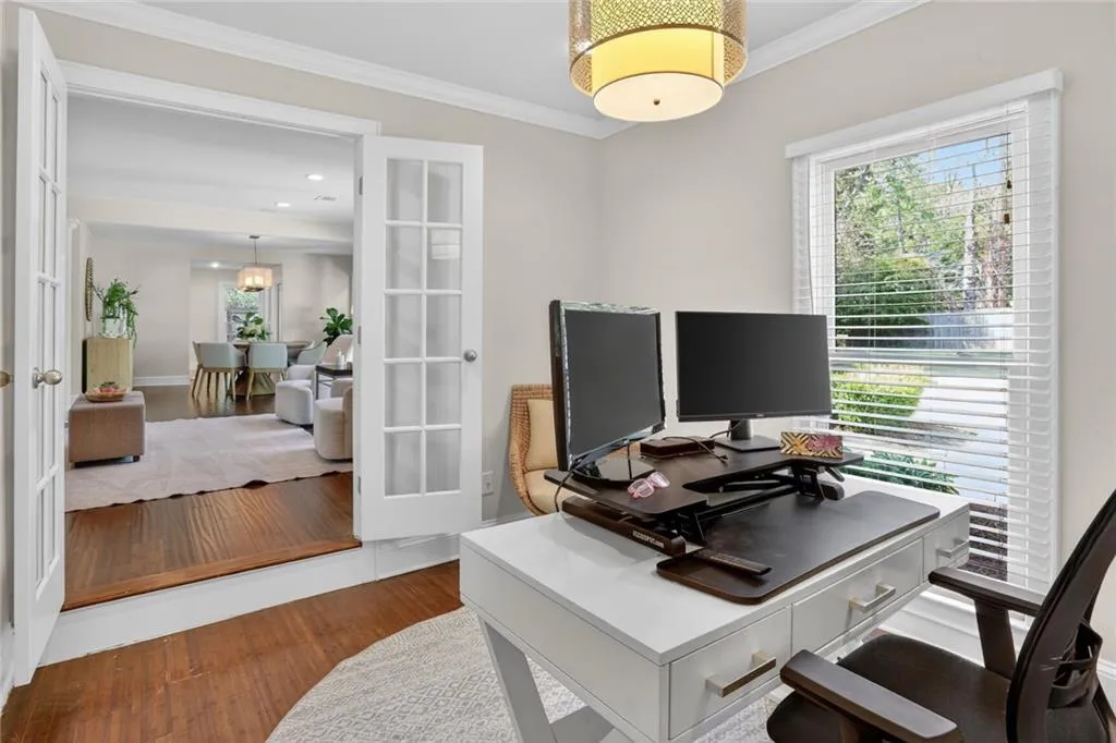 Office featuring ornamental molding, wood finished floors, and french doors