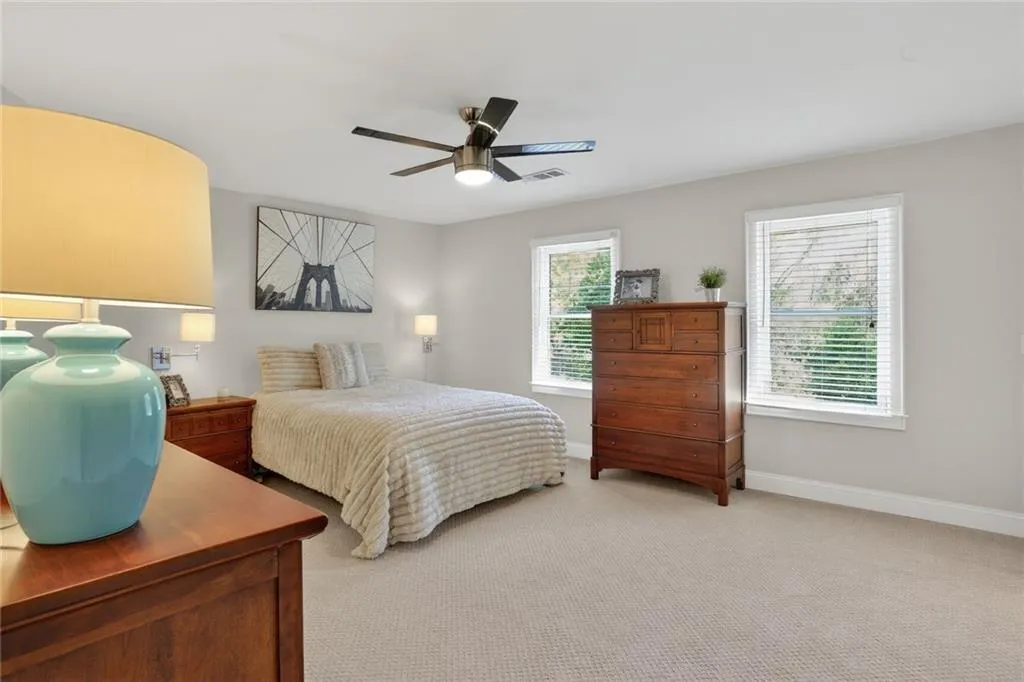 Bedroom featuring light colored carpet and ceiling fan