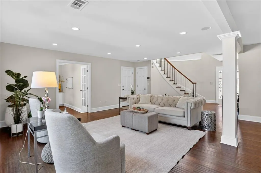 Living area with dark wood-style flooring and recessed lighting