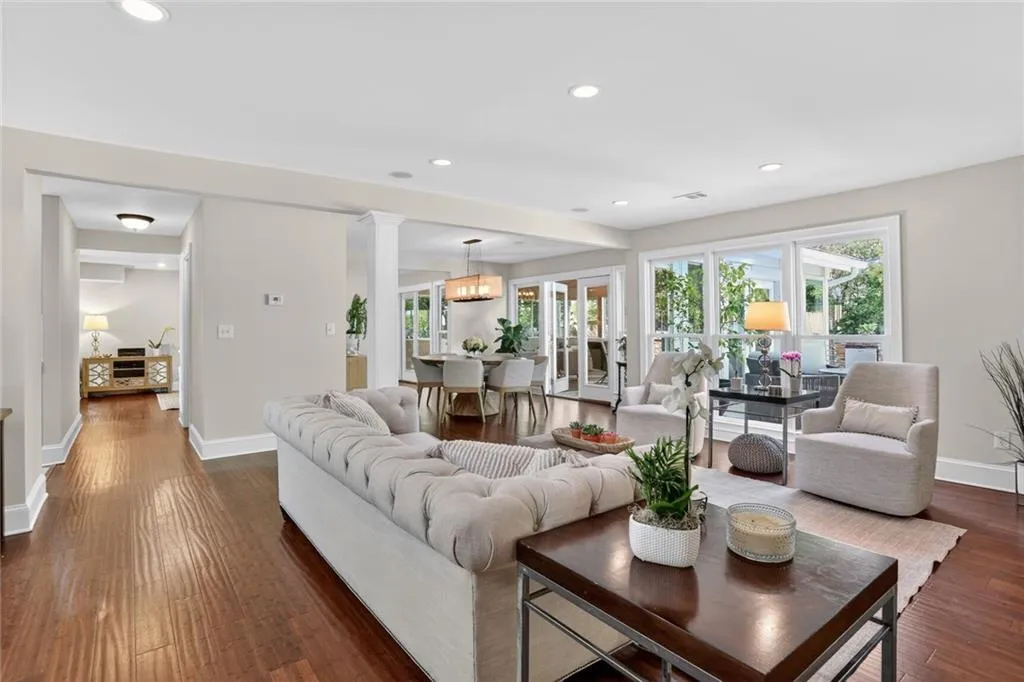 Living area featuring recessed lighting, plenty of natural light, and dark wood-style flooring