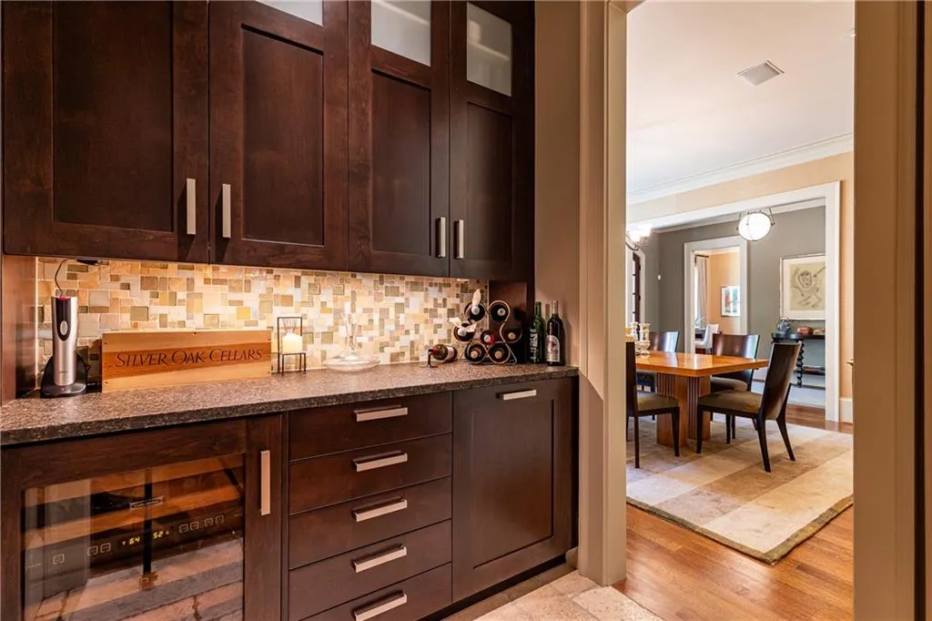 Sleek butler's pantry with lots of storage and wine cooler.