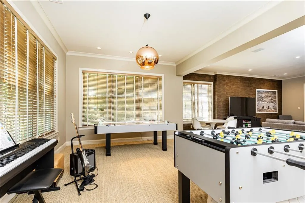 Brightly lit, daylight terrace level accommodates games, hobbies, media and more