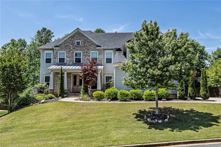 Stunning front exterior with covered porch and
professionally landscaped grounds.