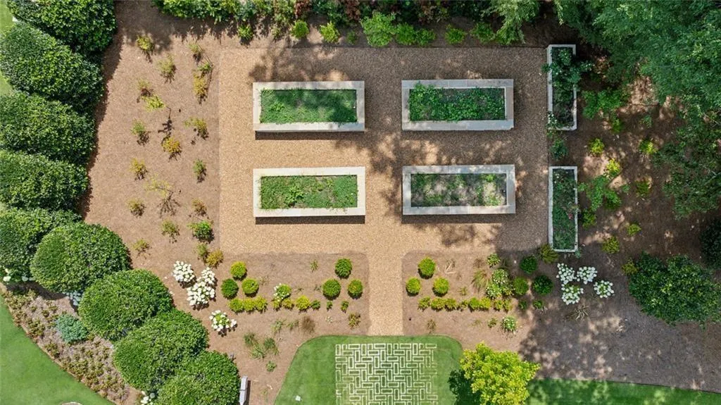 Raised garden beds with irrigation, hose connection, and parking pad.
