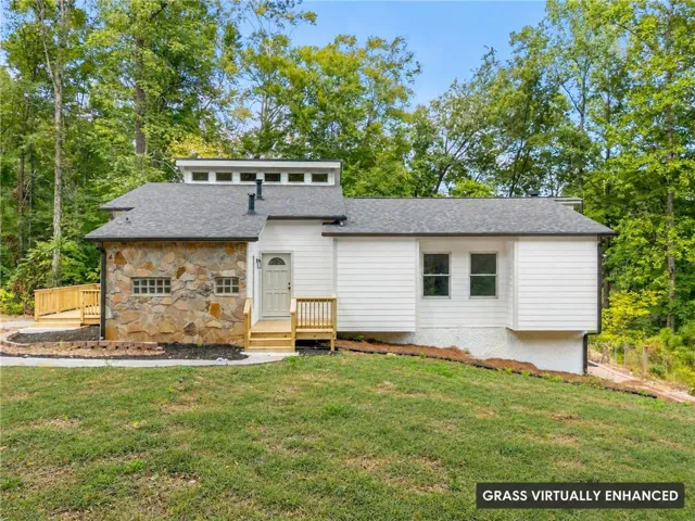 Stone facade with glass block windows, new deck, new roof, and white siding