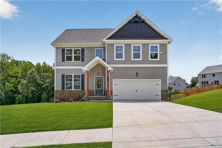 Two-story residence featuring a gabled roof and gray siding