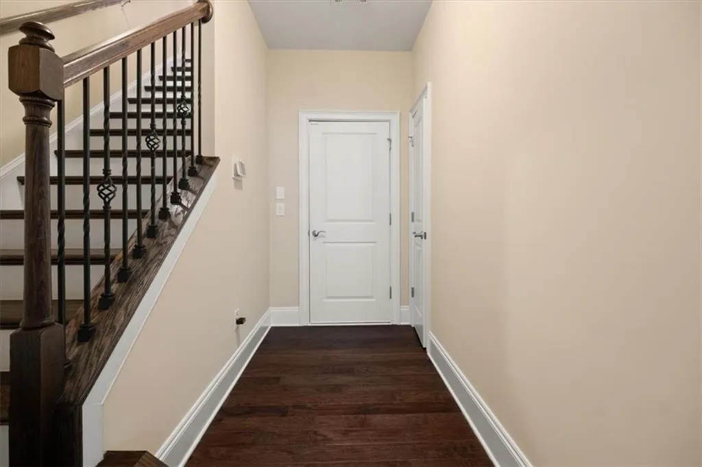 Hall with dark wood-type flooring