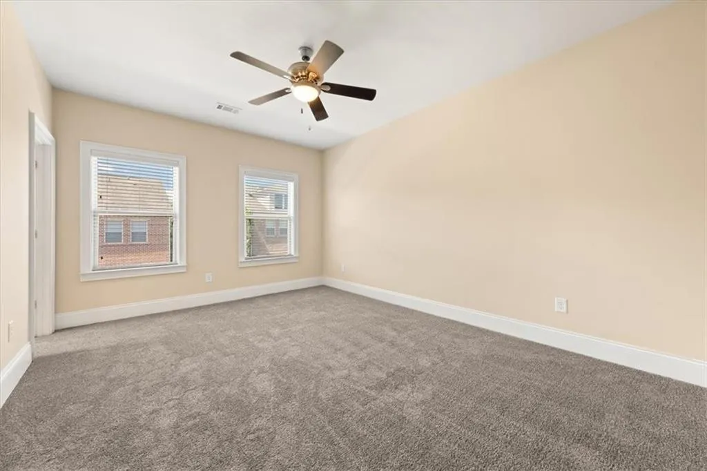 Spare room with carpet flooring and ceiling fan