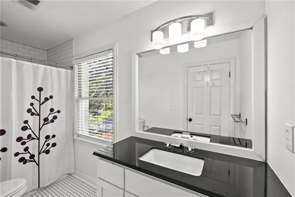 Bathroom with vanity and curtained shower