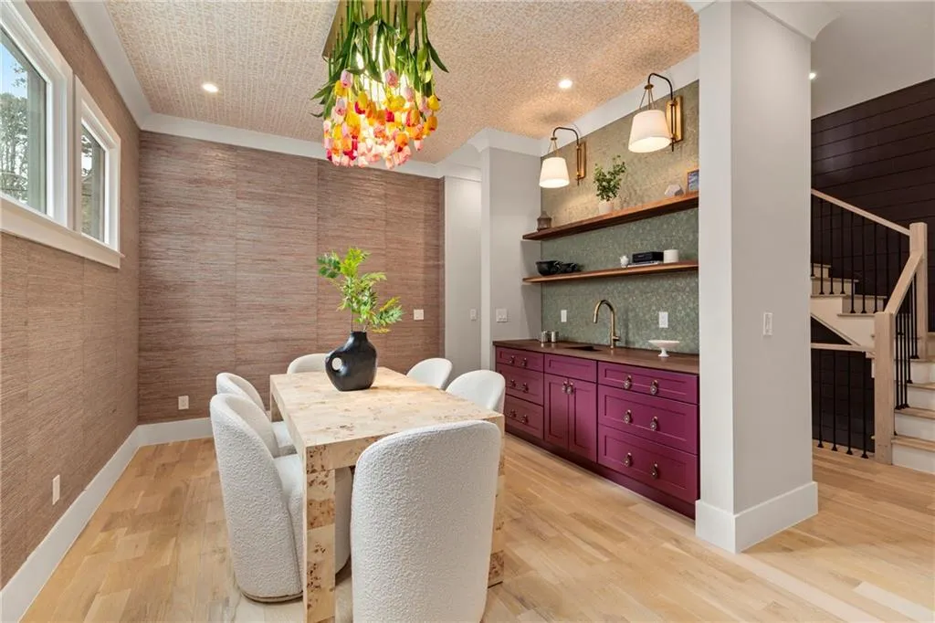 Dining space featuring light wood-type flooring, baseboards, and stairs
