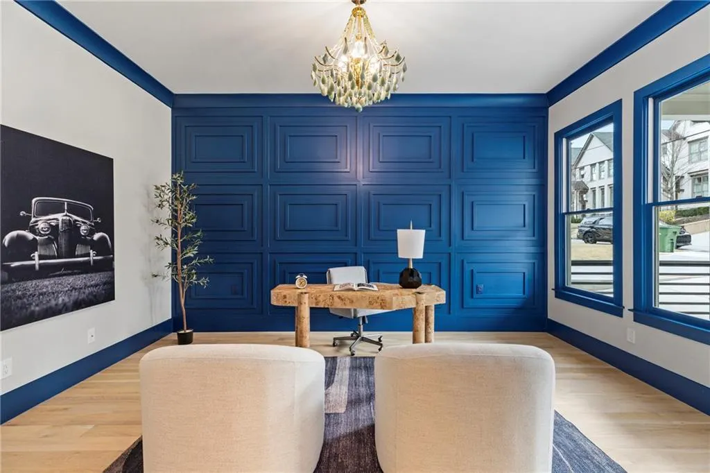 Dining space featuring light wood-style floors, baseboards, and a notable chandelier