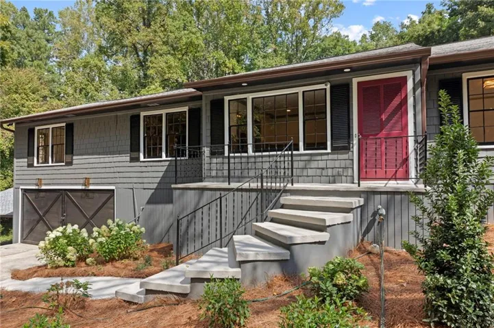 Grey shingle siding with dark shutters