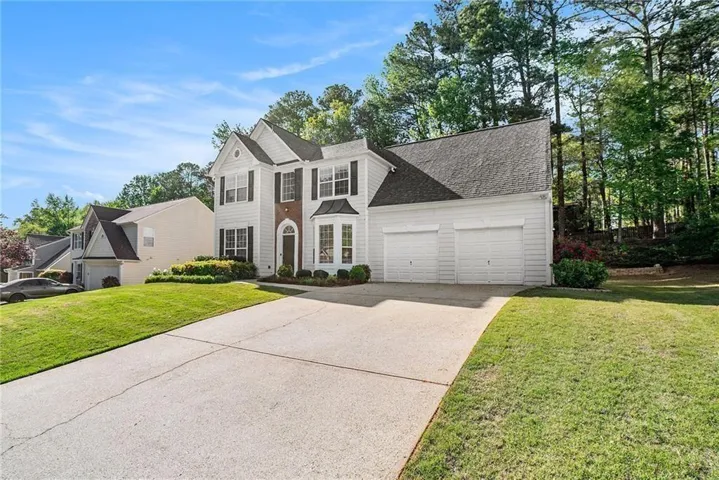 View of front of house featuring a shingled roof,