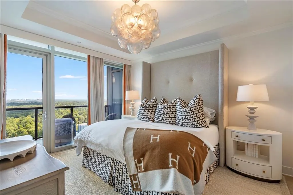 Floor-to-ceiling glass doors, recessed lighting, crown molding, and a balcony with clear glass railing