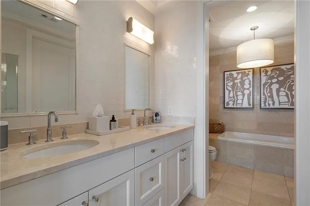 Dual vanity with undermount sinks, chrome fixtures, and a light-toned countertop