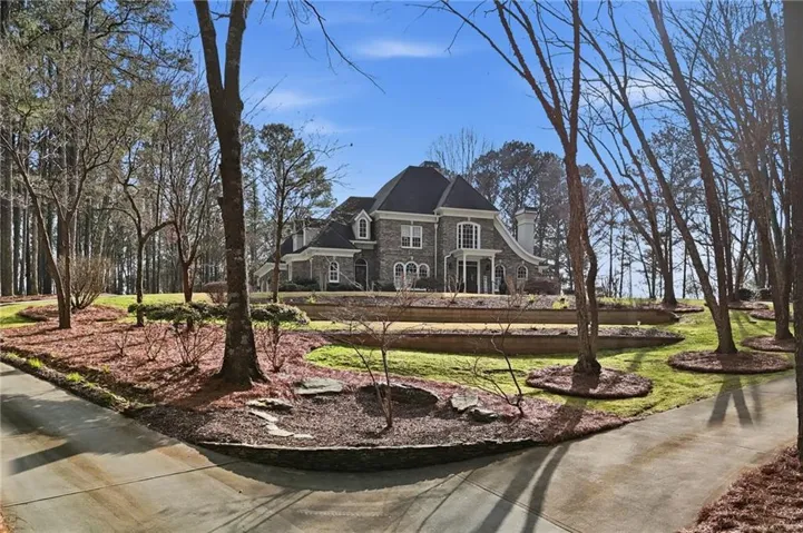 Stately stone and brick exterior residence with a columned front entrance