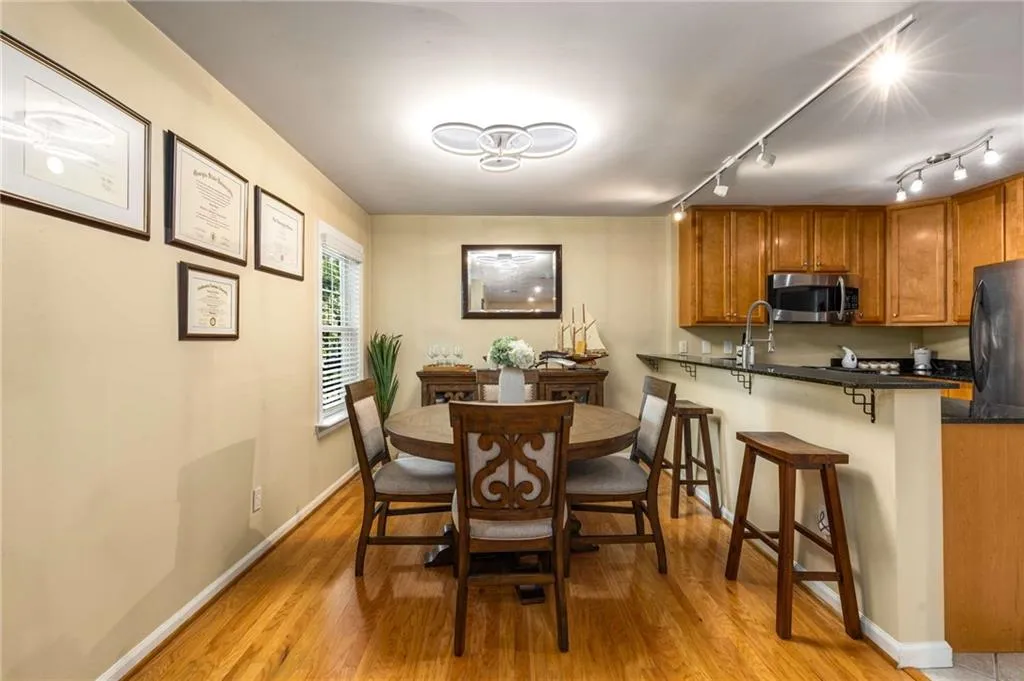 Dining area with wood floors, and breakfast bar