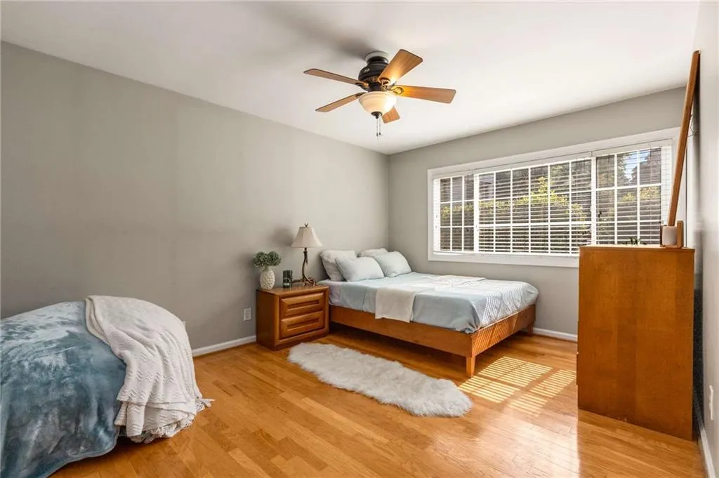Additional large bedroom equally sized to Primary Bedroom has lots of light and beautiful hardwood floors