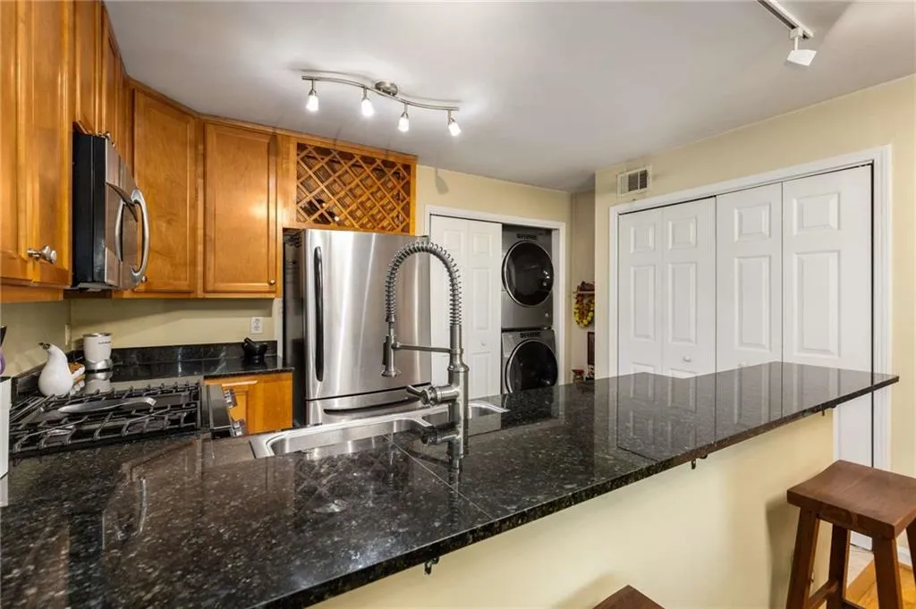 Kitchen featuring granite counters, double pantry, stainless steel appliances that all remain.